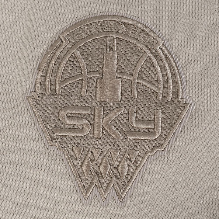 Embroidered patch with 'SKY' logo on a beige fabric background